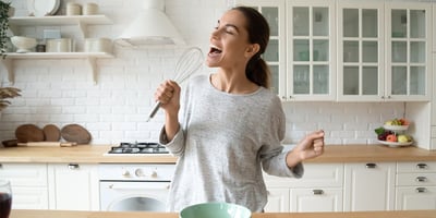 woman singing in kitchen
